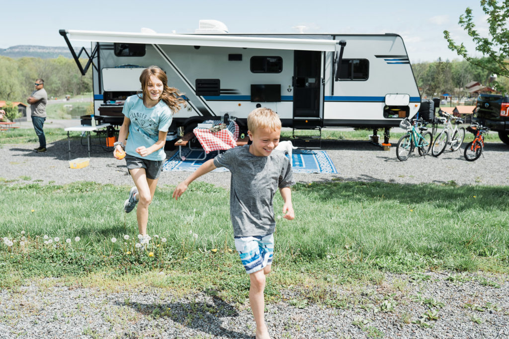Traveling in an RV with kids. Bunch O Balloons while camping at Jellystone Lazy River RV Resort Gardiner NY during the COVID 19 Pandemic. by Renee Ash Photography 