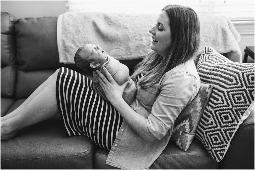 Mom and baby black and white photo on the couch by Renee Ash Photography Passaic County Lifestyle Newborn Photographer 