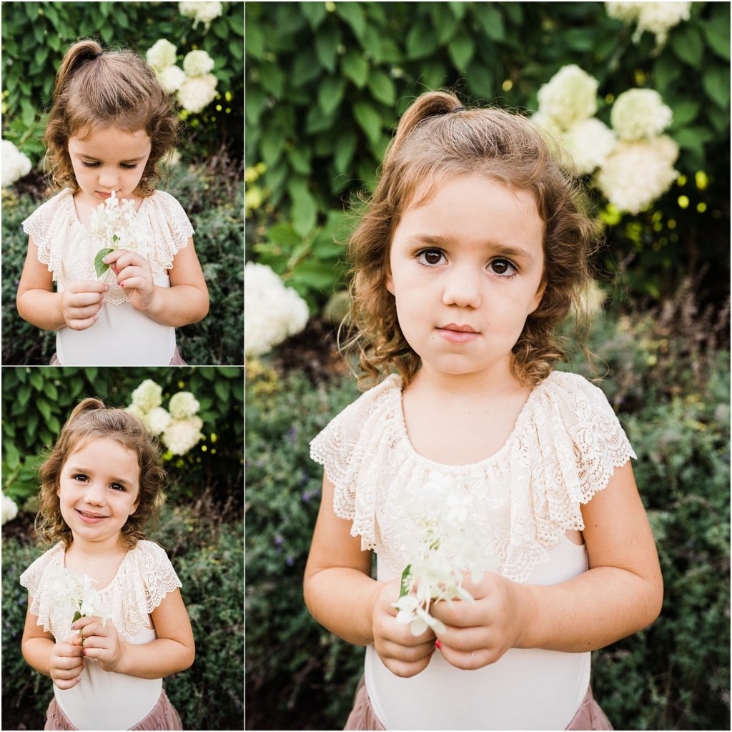 Little girl portrait dressed in a bailey's blossoms lace bodysuit holding flowers. Grand Cascades at Crystal springs resort, shot by Renee Ash Photography, Sussex County NJ family Photographer