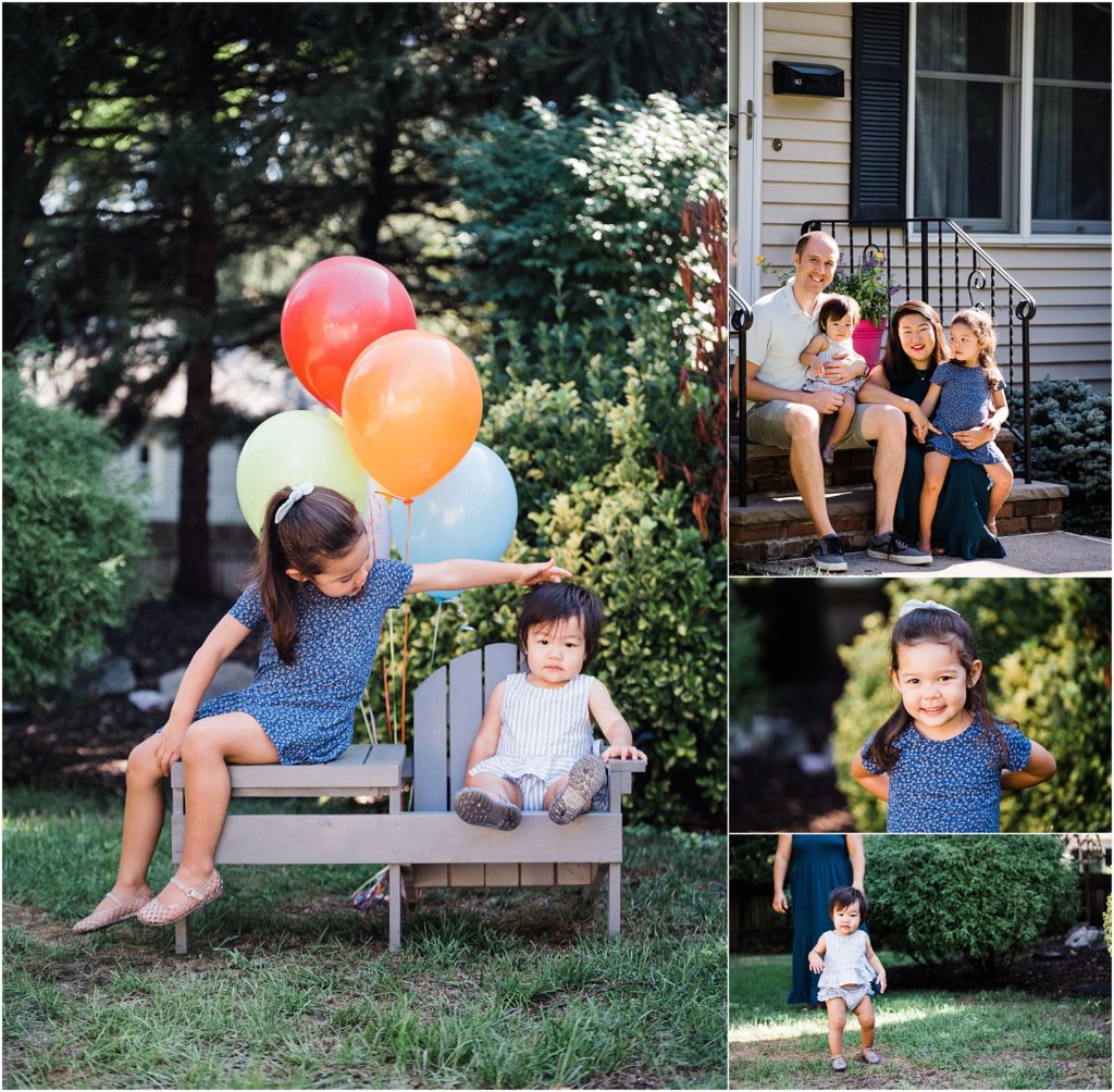 Family session with navy and grey colored wardrobe. Two sisters at their home. Backyard first birthday girl photos with rainbow colors balloons  Photos by Renee Ash photography, New Jersey 