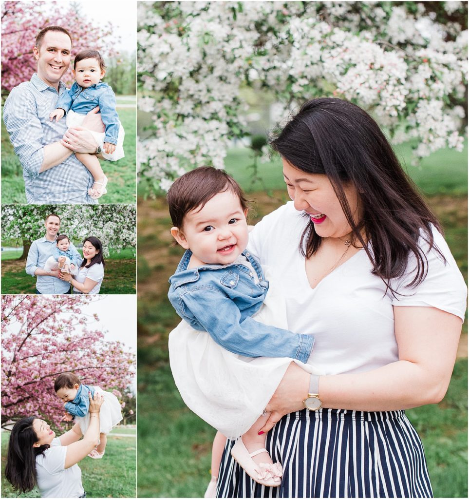 NJ Family and First birthday Photographer. Little girl First birthday session in Morris County New Jersey with a family of three in the white and pink cherry blossom trees. what to wear for your spring family photos. 