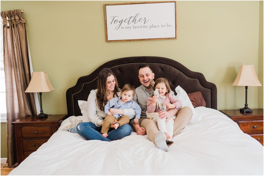  a family of four in the master bedroom  NJ Family Photographers Renee Ash Photography 