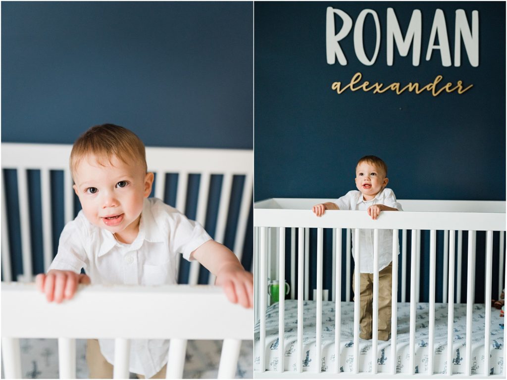 First birthday photos with a one year old boy in nursery with navy blue walls, and a white crib. by Renee Ash New Jersey photographers