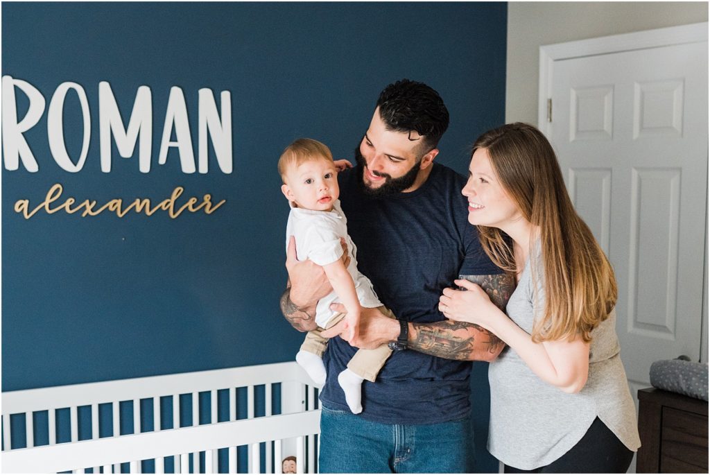 Family of three at home  in the nursery with a toddler boy. Maternity photos at home. navy blue, white and gold nursery.  lifestyle First birthday pictures at home. by Renee Ash New Jersey photographers