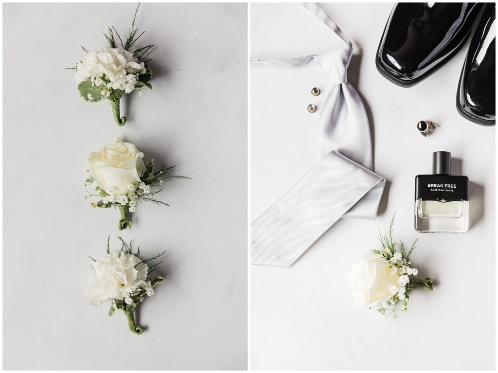 Groom's details suite. White rose boutonnierres, grey tie, black tuxedo shoes. Grace Church in Randolph  New Jersey. Photo by Renee Ash Photography