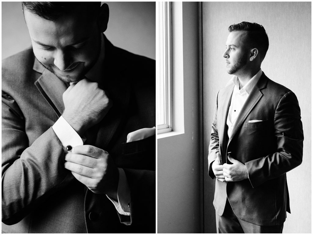 Black and white photos of the groom standing by a window getting ready in the church on his wedding day at the Photo by Renee Ash Photography