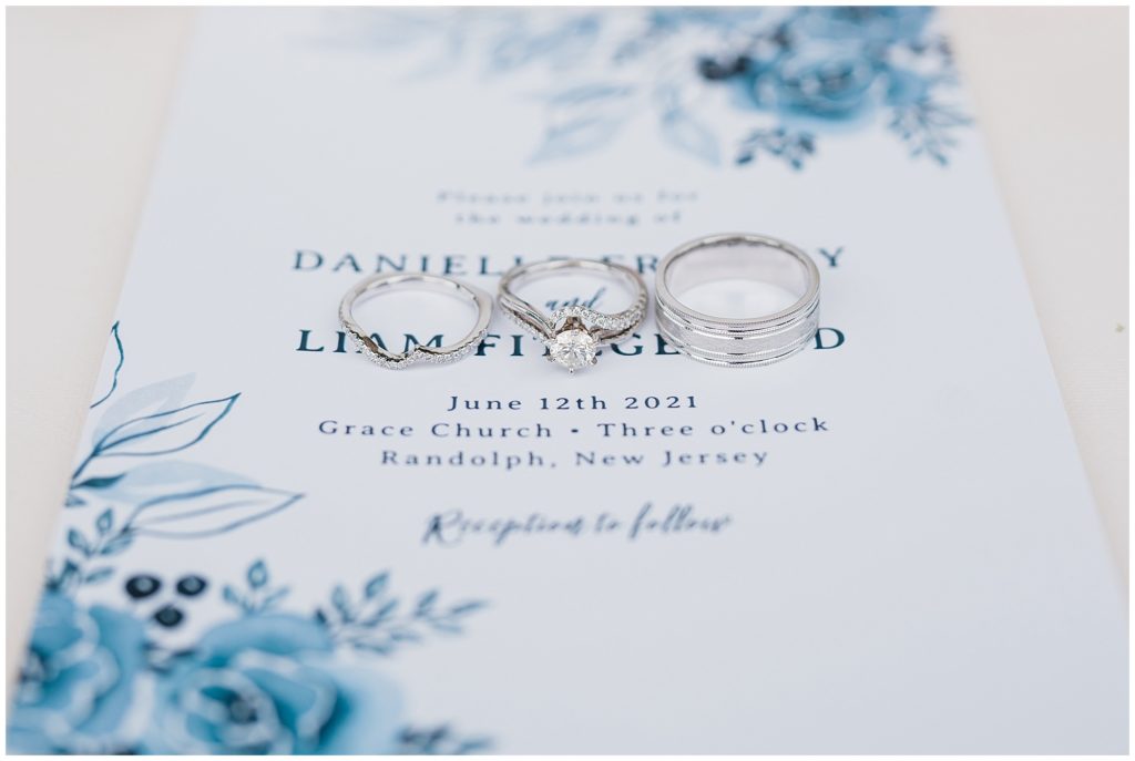 Bridal details three wedding rings resting on the invitation suite by the dateCl. ub at Picatinny in dover New Jersey. Photo by Renee Ash Photography
