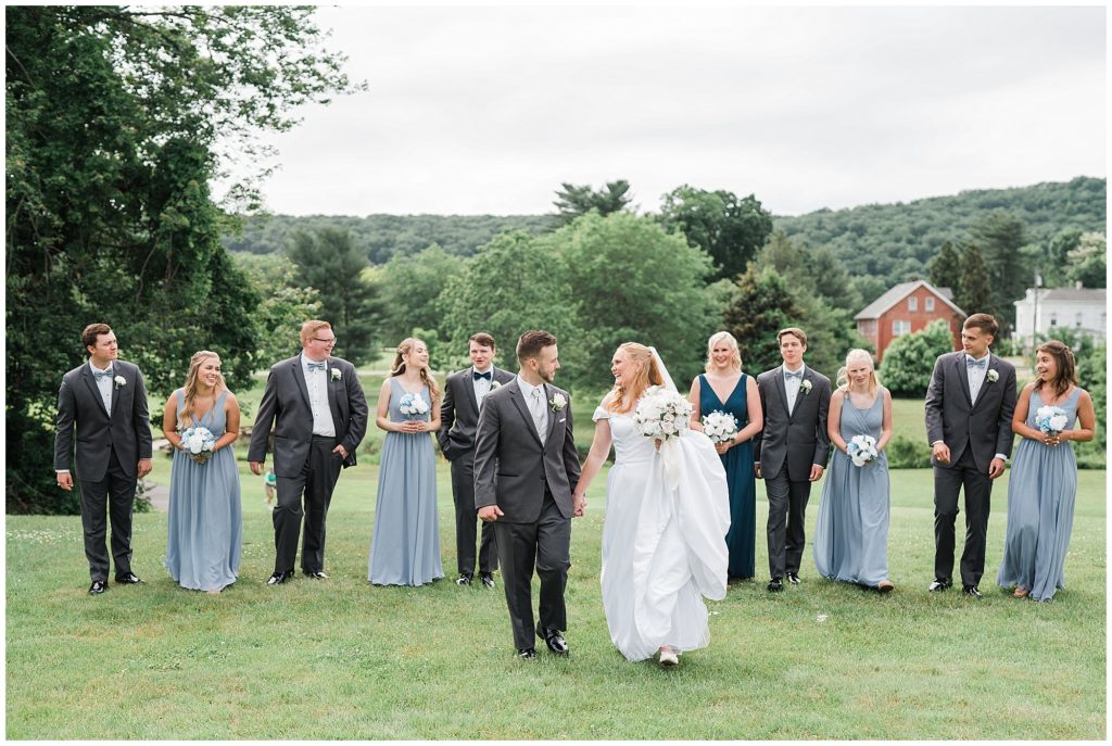Outdoor bridal party portraits on their wedding day at the Club at Picatinny in dover New Jersey. Photo by Renee Ash Photography Pale blue bridesmaids dresses by Azazie. Suit rentals by Mens warehouse.