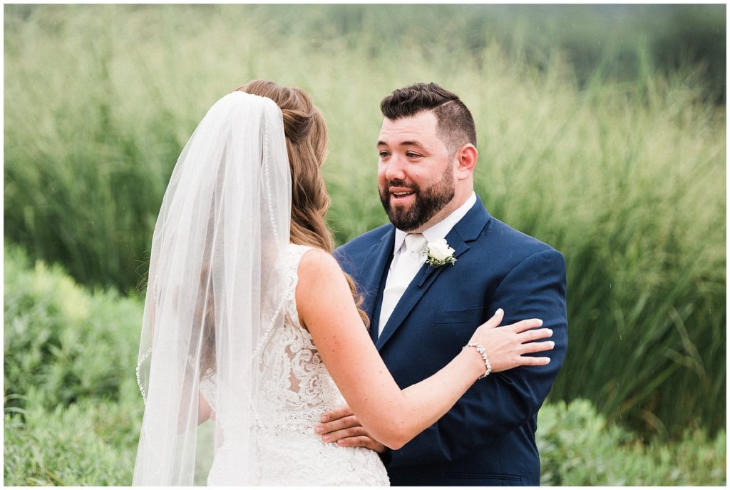 Groom's reaction during their first look before the ceremony on their summer wedding day at Ballyowen Golf Club in Hamburg NJ. By Renee Ash Photography