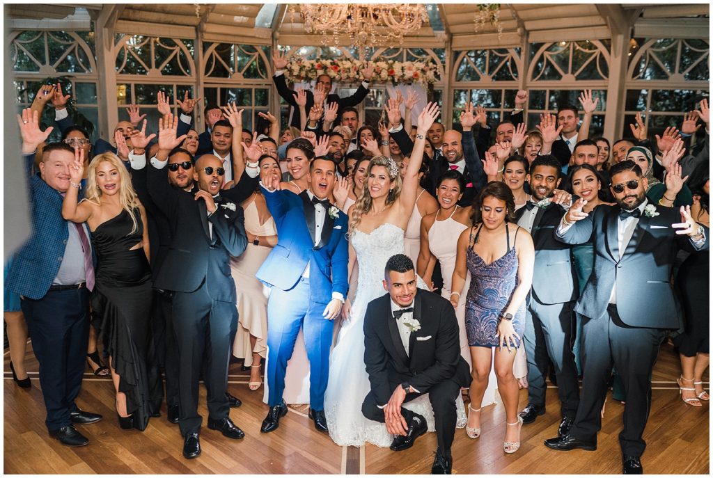 bride and groom reception group photo with all their guests at the brownstone in Paterson NJ.  Renee Ash Photography