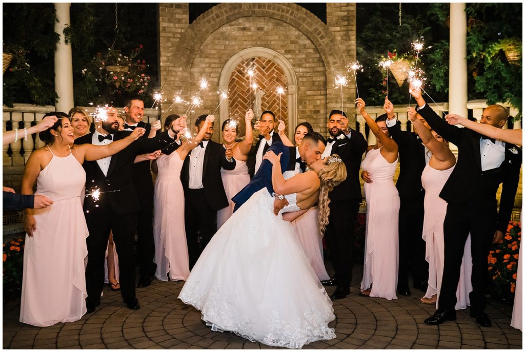 bride and groom sparker exit with their bridal party at the brownstone summer wedding.  Renee Ash Photography