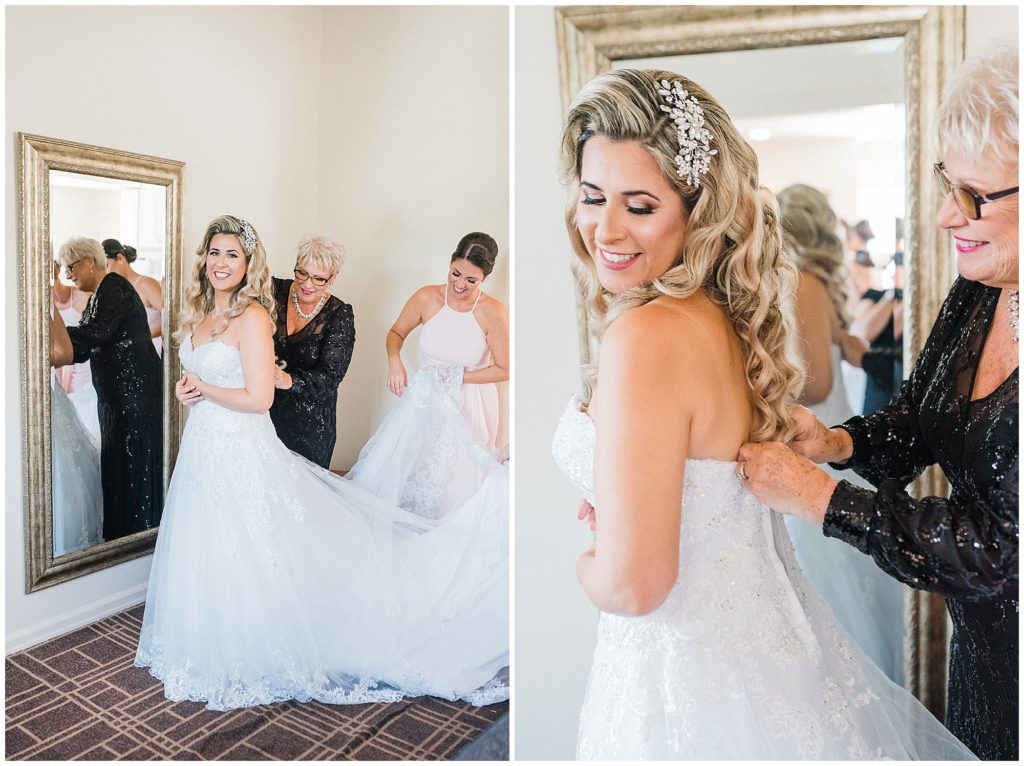 Bride with her mother and sister getting her into her gown.  fluffing her dress as she gets ready on her wedding day at the Brownstone.  Renee Ash Photography