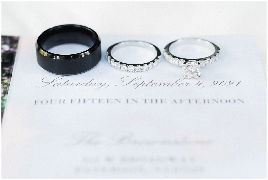 bridal wedding day details. bride and Groom's rings on their wedding invitation at the Brownstone.  Renee Ash Photography