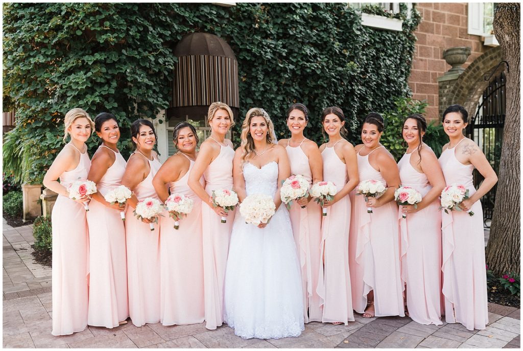 bride and her bridesmaids photo in pink gowns with white and pink flower bouquets at the Brownstone.  Renee Ash Photography