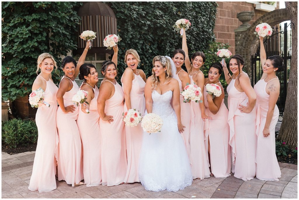 Fun bridesmaids photo in pink gowns with white and pink flower bouquets at the Brownstone.  Renee Ash Photography
