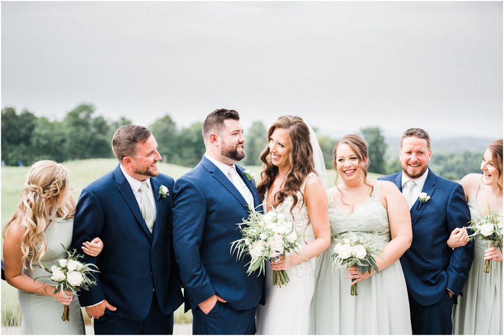 Bridal party portrait. Sage green bridesmaid dresses, Navy blue groomsmen suits. Ballyowen at Crystal Springs summer wedding. Renee Ash Photography