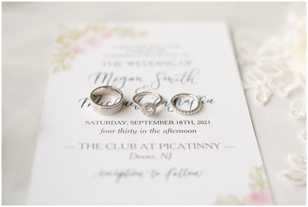 Three wedding rings on the wedding invitation. Renee Ash Photography
