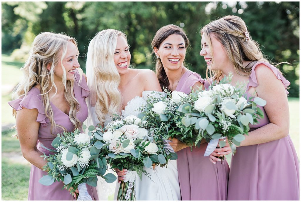 Bride and three bridesmaids at The Club at Picatinny.  Pronovias wedding dress. Blush pink Bridesmaids dresses from Azazie. White rose and Eucalyptus bouquets. Renee Ash Photography