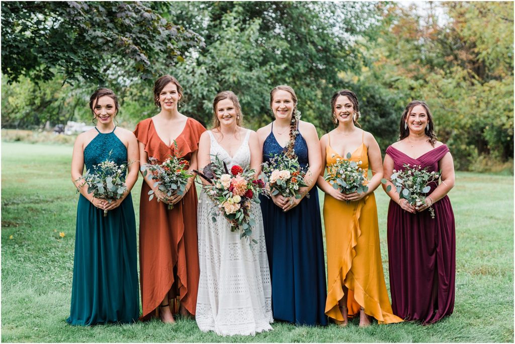 bridesmaids in multiple jewwel tones for a fall boho wedding. baltic born bridesmaid dresses. Emmerich Tree Farm Wedding warwick NY 
