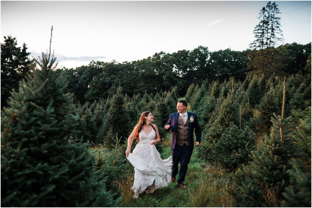 bride and groom running through christmas trees at Emmerich Tree Farm Wedding warwick NY 