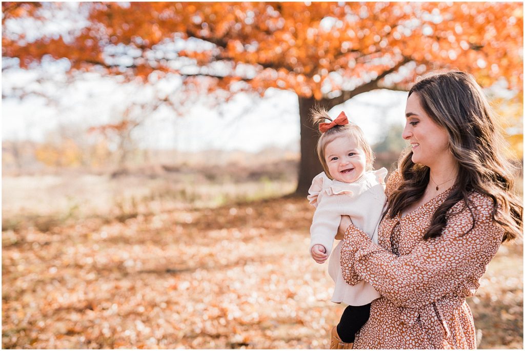mother daughter first birthday pictures with a one year old girl in the fall leaves in October. Central Park of Morris Plains NJ Family photographer Renee Ash Photography