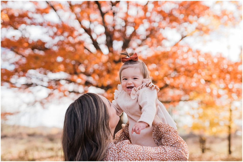 mother and daughter first birthday pictures with a one year old girl in the fall leaves in October. Central Park of Morris Plains NJ Family photographer Renee Ash Photography