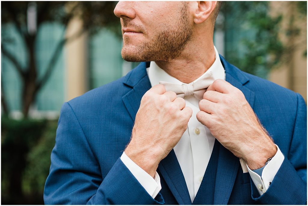Groom with Navy blue suit and beige bow tie.  Waterloo Village Wedding Venue  New Jersey Renee Ash Photography