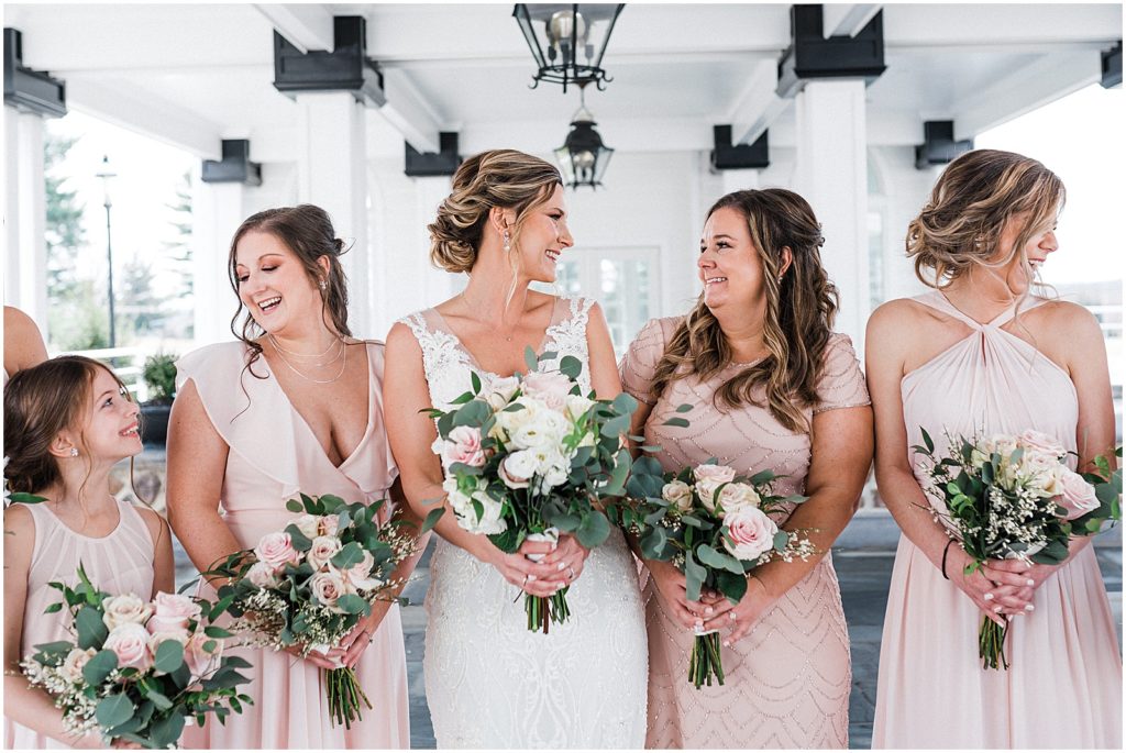 Bride and Bridesmaid portraits under the car port at the The Ryland Inn Whitehouse station NJ. Pink mix and match bridesmaid dresses.  Renee Ash Photography Wedding photographer