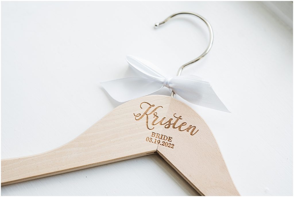 Custom wooden bride and Bridesmaid hangar with bride's name and wedding date engraved. The Coach House at Ryland Inn Wedding
