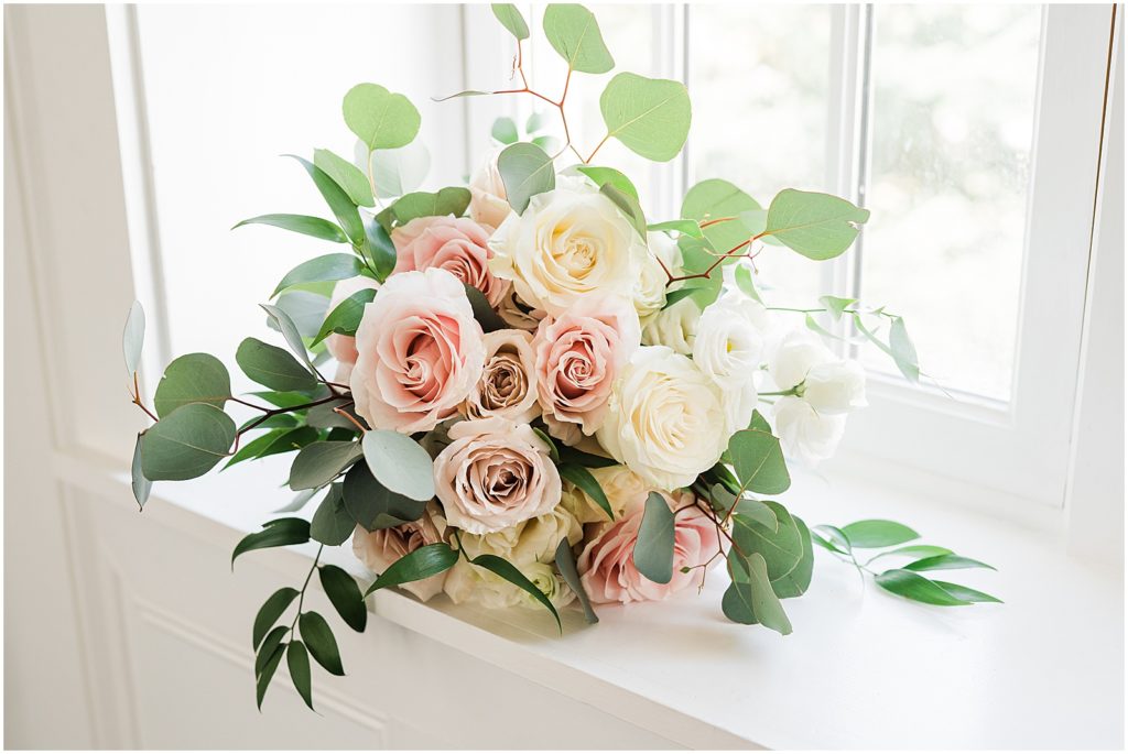 Pink and cream bride's rose wedding bouquet with eucalyptus and greenery at The Coach House at the Ryland Inn Wedding