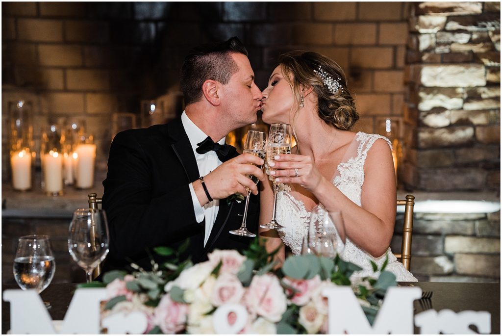 Bride and Groom's at their sweetheart table The coach house and the Ryland Inn Winter wedding. by Renee Ash Photography