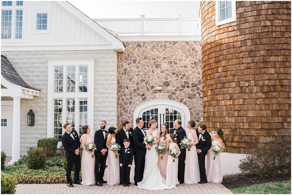 Bridal party photos in front of the coach house and the Ryland Inn Winter wedding. by Renee Ash Photography