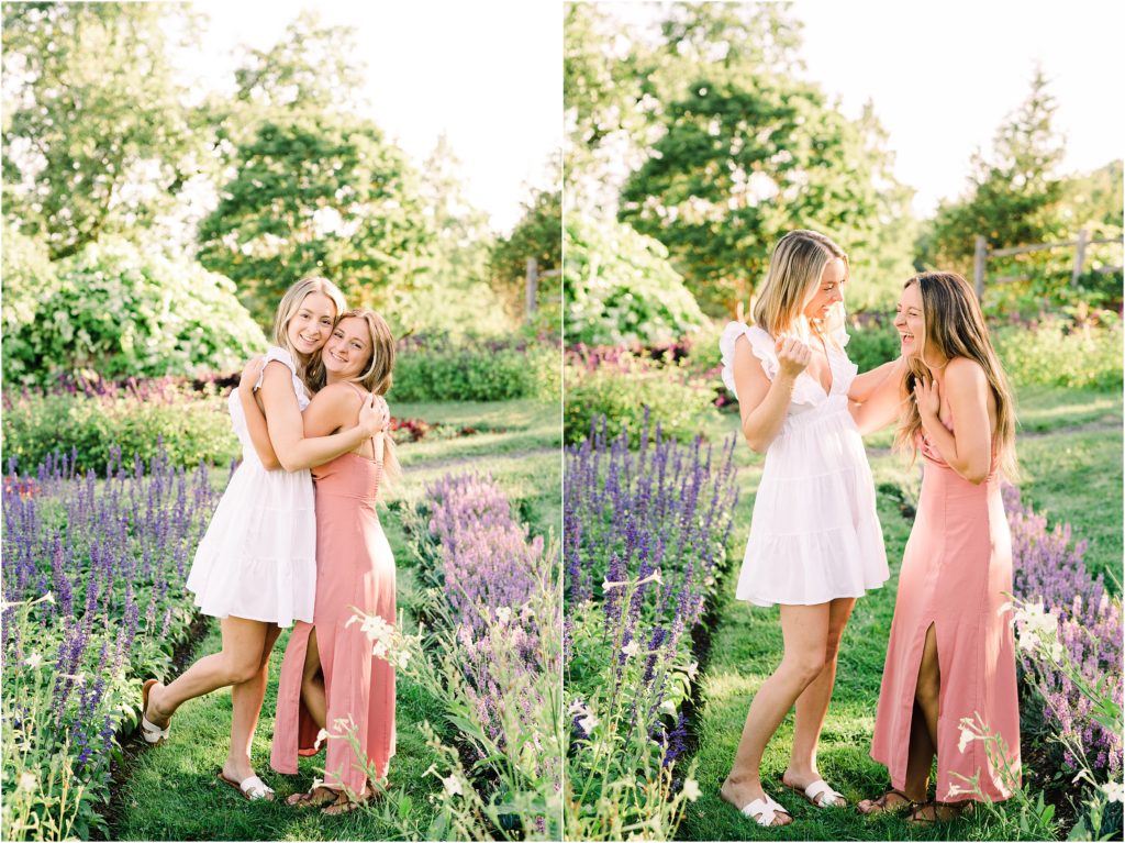 adult twin sisters hugging and laughing in a lavender garden wearing a pink and a white dress. At the Mohonk Mountain House in New Paltz New York