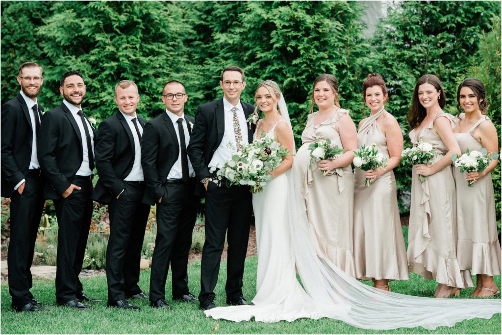 Champagne bridesmaid dresses and black groomsmen suits. The Refinery at Perona Farms wedding venue. New Jersey Wedding photographers