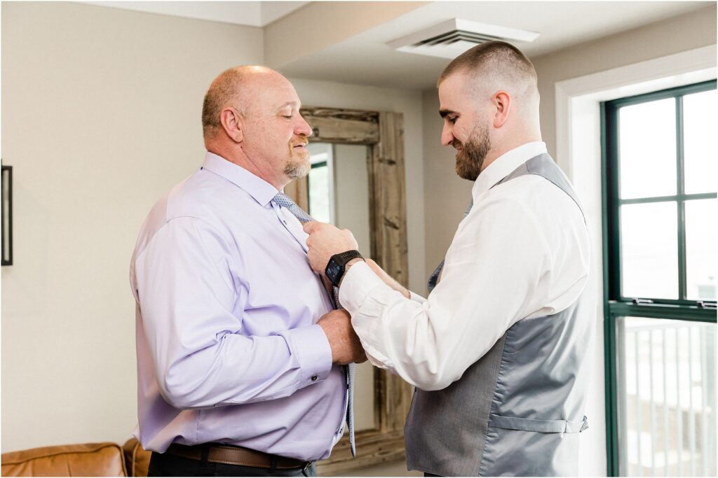 Groom's getting ready. Groom with his dad getting ready the morning of his wedding at the Appalachian hotel at Mountain creek's red tail lodge wedding.