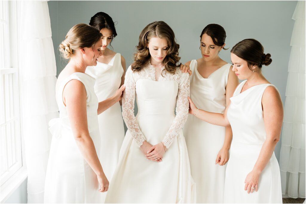 Prayer over the bride with the bridesmaids the morning of her wedding day.  Classic black and white wedding day at the Conservatory at the Sussex County Fairgrounds. Renee Ash Photography, NJ wedding photographer. 