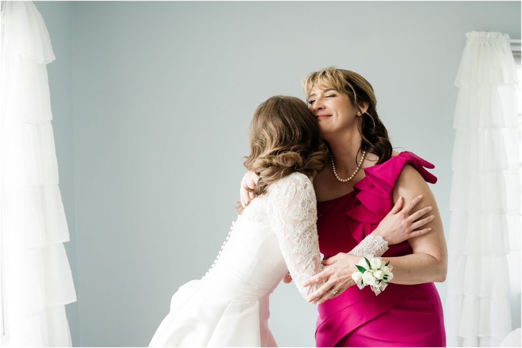 Mother of the bride pink dress. 
Sweet mother and bride moment during the morning . Classic black and white wedding day at the Conservatory at the Sussex County Fairgrounds. Renee Ash Photography, NJ wedding photographer. 