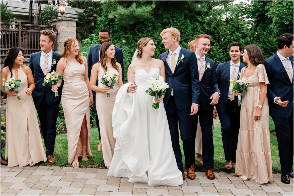 Wedding party portraits at the Sherwood chalet at Forest Lodge wedding venue. Champagne bridesmaids dresses, navy groomsmen suits with champagne ties.  Bouquets by The Botanical Box. Renee Ash Photography, NJ wedding photographer.