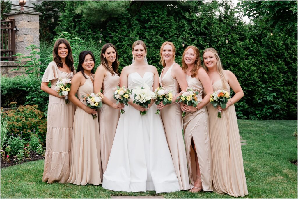 Wedding party portraits at the Sherwood chalet at Forest Lodge wedding venue. Champagne bridesmaids dresses. Bouquets by The Botanical Box. Renee Ash Photography, NJ wedding photographer.