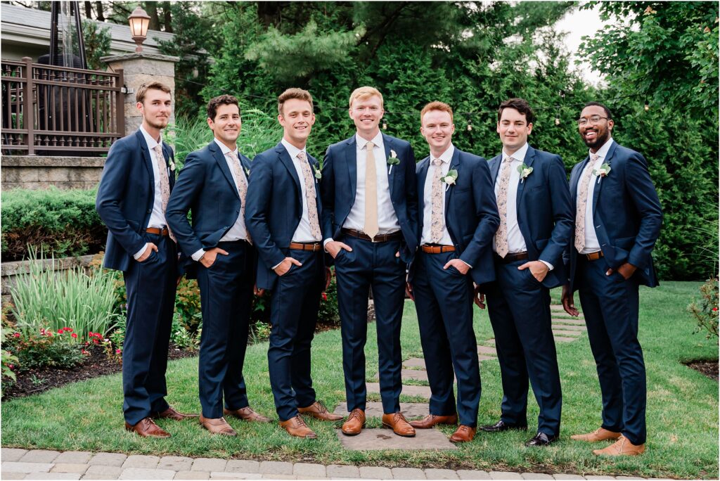 Wedding party portraits at the Sherwood chalet at Forest Lodge wedding venue. navy groomsmen suits with champagne ties.  Bouquets by The Botanical Box. Renee Ash Photography, NJ wedding photographer.