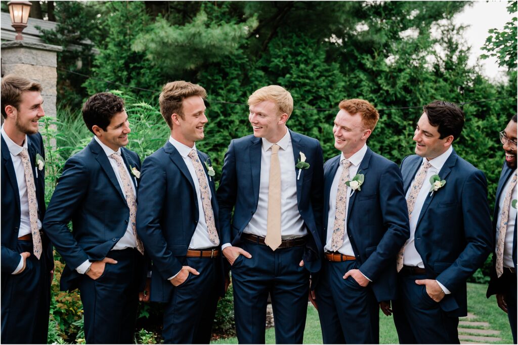 Wedding party portraits at the Sherwood chalet at Forest Lodge wedding venue. Champagne bridesmaids dresses, navy groomsmen suits with champagne ties.  Boutonnieres by The Botanical Box. Renee Ash Photography, NJ wedding 