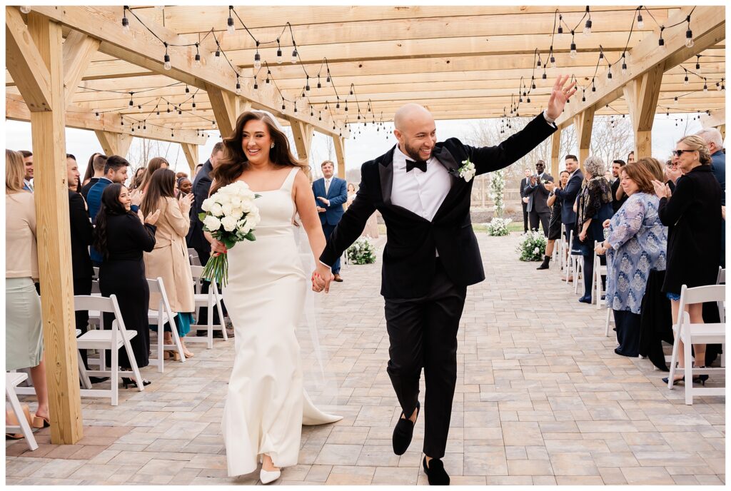 bride and groom walking down the aisle at The Barn at Villa Venezia Goshen NY wedding photographer