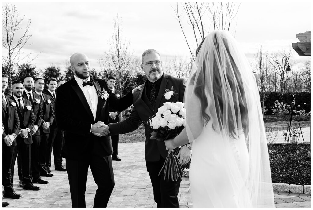 dad handing off the bride to her groom during the ceremony at The Barn at villa venezia 