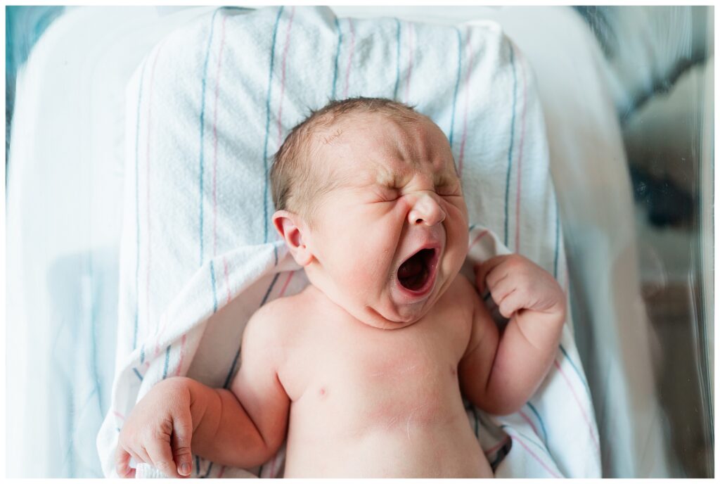 Baby yawning during professional hospital photos for a new baby in morristown NJ Renee Ash Photography