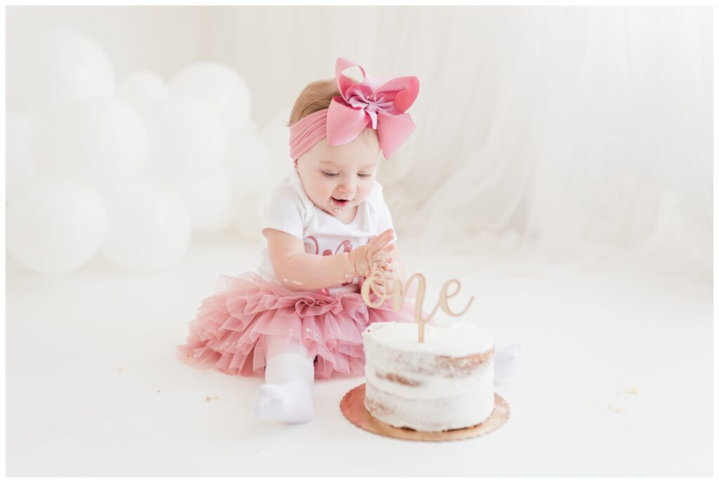 pink bow first birthday cake smash photographer in sussex county new jersey | Renee Ash Photography