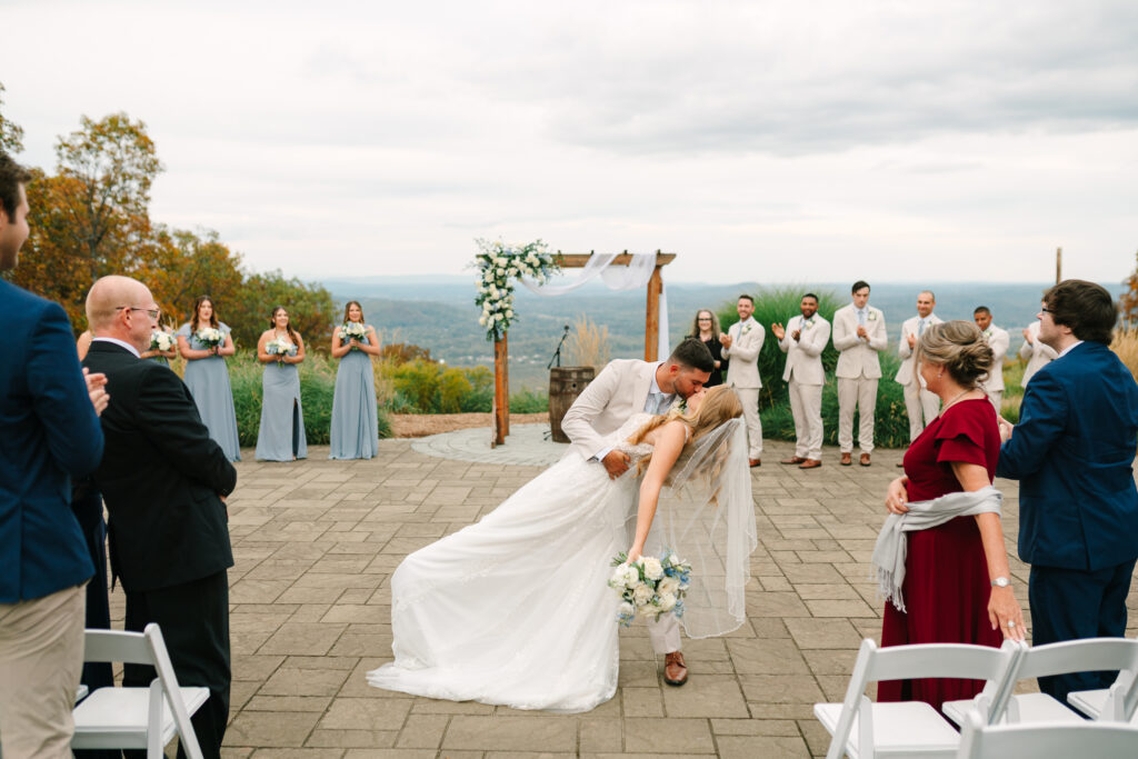bride and groom's first kiss after their mountain top wedding ceremony at a Late September Mountain Creek Wedding at Red Tail Lodge. 