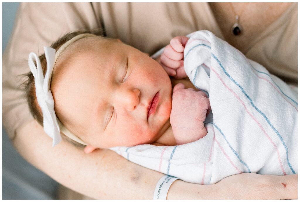 Parents holding their newborn together during Fresh 48 session in New Jersey hospital