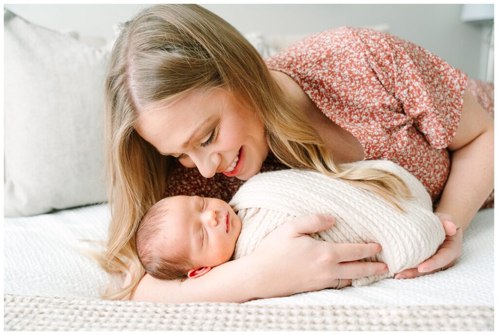 Lifestyle newborn photos taken at home in Morris County NJ showing a mother cuddling her newborn