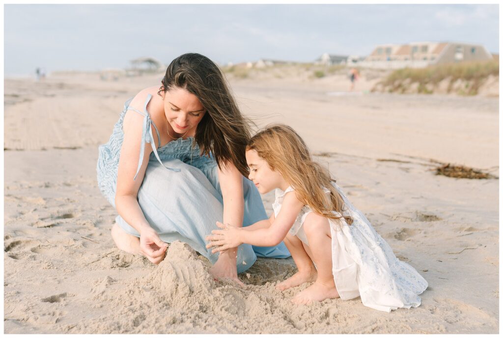 Mother and daughter building a sandcastle while playing together on the beach at the NJ Shore on Long Beach Island, Beach Haven LBI. With NJ Family photographer Renee Ash Photography