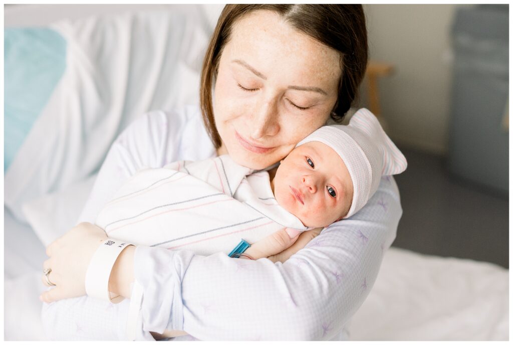 mom holding a Baby boy just 24 hours old in the hospital after delivery at Morristown Medical Center during baby's first photo shoot with Fresh 48 Newborn Photographer renee Ash Photography